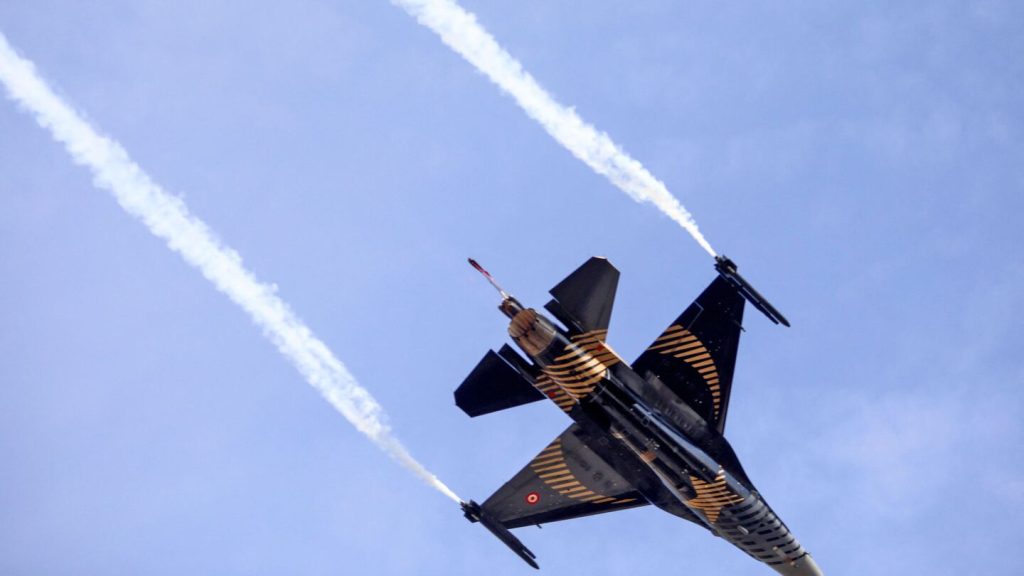 A Turkish Air Force F-16 fighter aircraft of the "Solo Turk" solo aerobatics display team performs aerial maneuvers